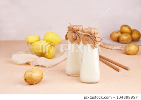 Potato milk in bottles. Healthy vegetarian and vegan drink Potato milk in bottles. Healthy vegetarian and vegan drink 134899957