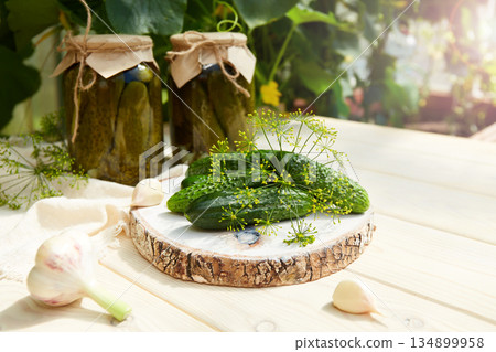 Pickled cucumbers in a jar, fresh cucumbers, herbs, garlic and dill for canning 134899958