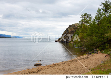 Rocky shore of a lake on a cloudy summer day 134899991