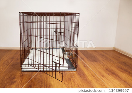 An empty cage for pets in an apartment. An empty cage for pets in an apartment. 134899997