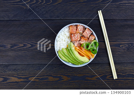 Hawaiian salmon fish poke bowl with rice, avocado, cucumber, carrot 134900103
