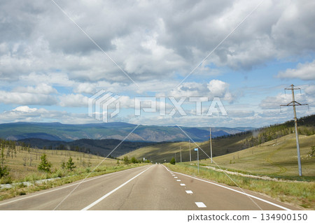 Beautiful asphalt road to lake Baikal on a Sunny autumn day Beautiful asphalt road to lake Baikal on a Sunny autumn day 134900150