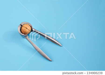 Walnut kernels in a bowls on a blue background. Walnut kernels in a bowls on a blue background. 134900239