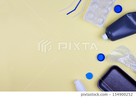 Plastic waste for recycling and reuse on yellow background. 134900252