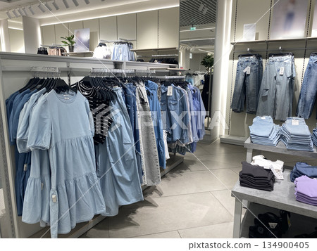 Stylish clothing display featuring denim and casual wear in a modern boutique Stylish clothing display featuring denim and casual wear in a modern boutique 134900405
