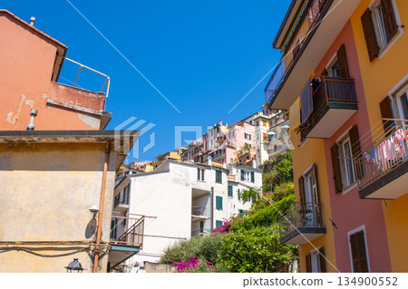 Italian shutters on the windows balcony of multicolored house. Summer in Cinque Terre Italian shutters on the windows balcony of multicolored house. Summer in Cinque Terre 134900552