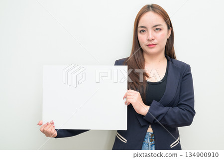 Portrait of young Asian businesswoman against white background showing copy space from white board 134900910