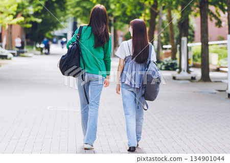 College student walking on campus with friends College student walking on campus with friends 134901044