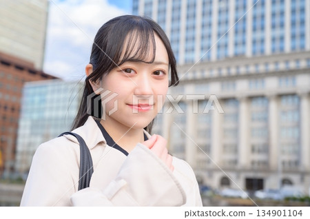 Japanese businesswoman standing in an office district Japanese businesswoman standing in an office district 134901104
