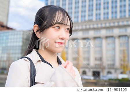 Japanese businesswoman standing in an office district Japanese businesswoman standing in an office district 134901105