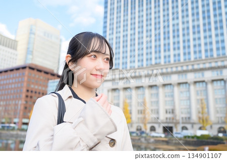 Japanese businesswoman standing in an office district Japanese businesswoman standing in an office district 134901107