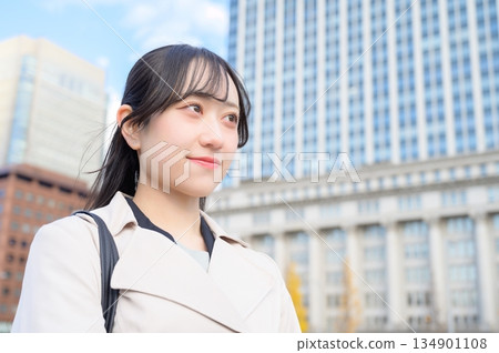 Japanese businesswoman standing in an office district Japanese businesswoman standing in an office district 134901108