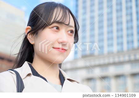 Japanese businesswoman standing in an office district Japanese businesswoman standing in an office district 134901109