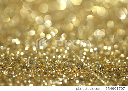 Gold shimmer glitter background with focus and bokeh Gold shimmer glitter background with focus and bokeh 134901707