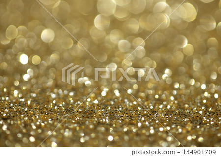 Gold shimmer glitter background with focus and bokeh 134901709