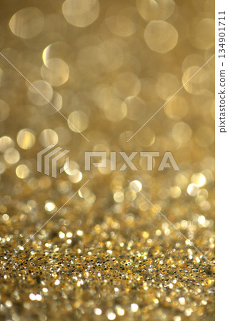Gold shimmer glitter background with focus and bokeh Gold shimmer glitter background with focus and bokeh 134901711