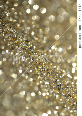 Gold shimmer glitter background with focus and bokeh Gold shimmer glitter background with focus and bokeh 134901712