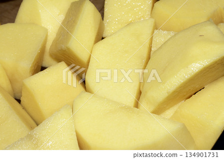 Close up of raw potatoes peeled and chopped ready to be roasted 134901731