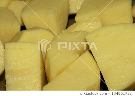 Close up of raw potatoes peeled and chopped ready to be roasted 134901732