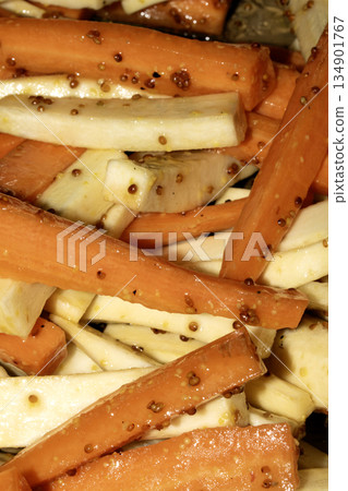 Close up of roasted vegetables honey and mustard parsnip and carrots side dish for Sunday roast dinner Close up of roasted vegetables honey and mustard parsnip and carrots side dish for Sunday roast dinner 134901767