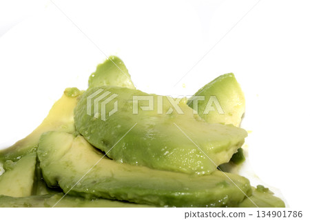 Close up of green fresh avocado sliced on white background Close up of green fresh avocado sliced on white background 134901786