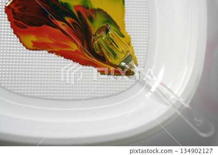 Paint colorful mix with a plastic fork Paint colorful mix with a plastic fork 134902127