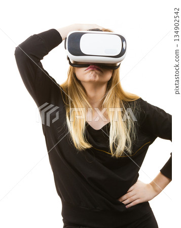 Woman wearing VR goggles 134902542