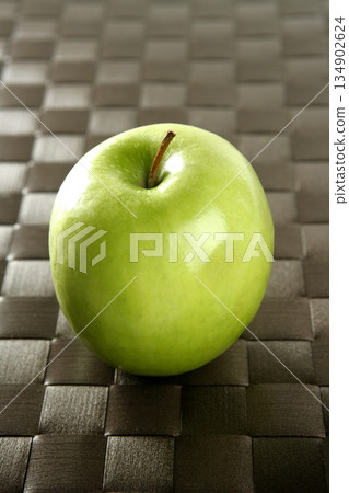 apple on a brown tablecloth apple on a brown tablecloth 134902624