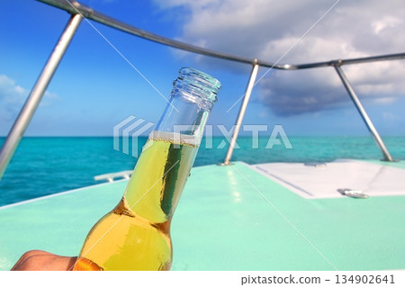beer on Caribbean boat bow deck turquoise sea 134902641