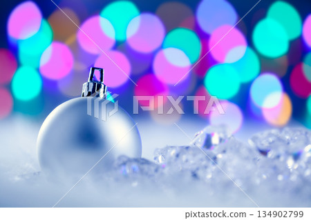 Christmas silver bauble in blurred lights Christmas silver bauble in blurred lights 134902799