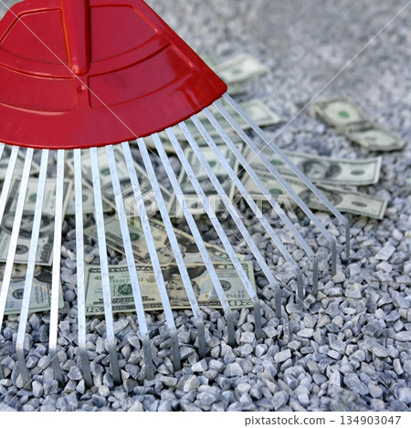 Cleaning black dolar money with rake, metaphor 134903047