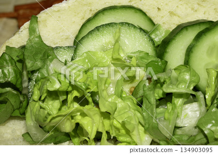 Close up of healthy lettuce and cucumber slices on bread 134903095