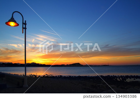 Sunset orange blue seascape light lamppost 134903386