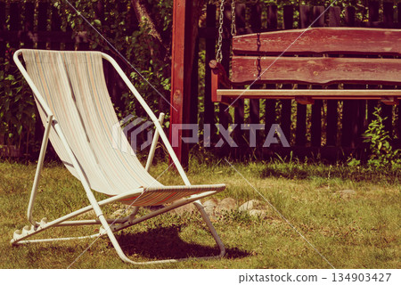 Garden with deck chair and swing Garden with deck chair and swing 134903427