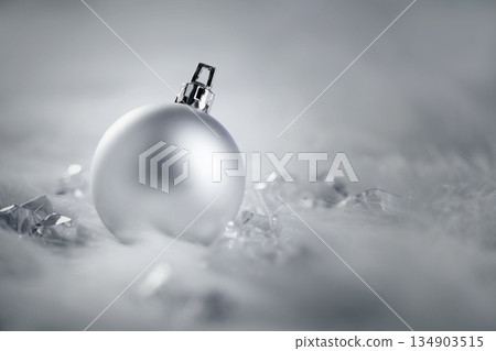 christmas silver bauble on fur snow and ice 134903515