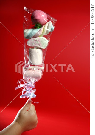 children hand with a stick full of sweet candy children hand with a stick full of sweet candy 134903517