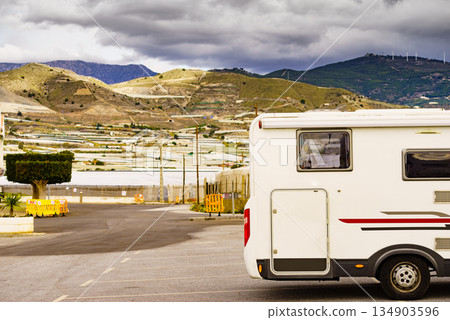 Camper against plastic greenhouses in Almeria Spain 134903596