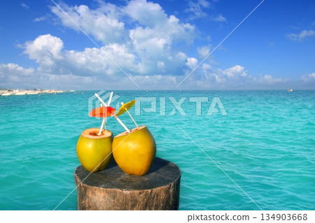 fresh two coconuts juice water straws in caribbean 134903668