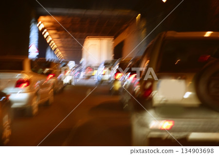 Cars moving traffic with brurred motion headlights on the tunnel Cars moving traffic with brurred motion headlights on the tunnel 134903698