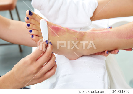 foot scrub pedicure woman leg in nail salon foot scrub pedicure woman leg in nail salon 134903802