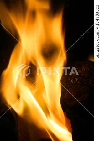 Orange fire over black background Orange fire over black background 134903823