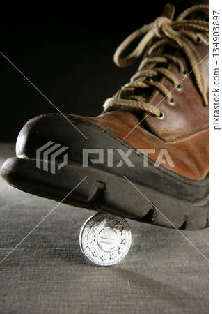 euro currency coin tread by a boot euro currency coin tread by a boot 134903897