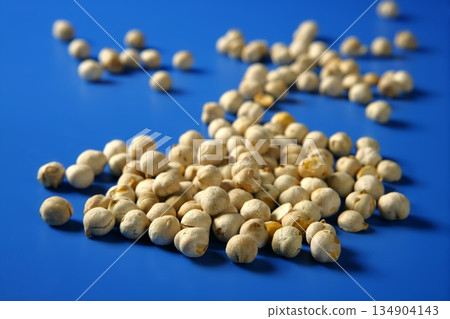 Chickpeas still spread over  blue background 134904143