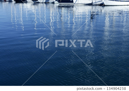 Sailboat blurred mast reflexion on the marina 134904238