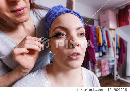 Woman getting her make up done by expert 134904328