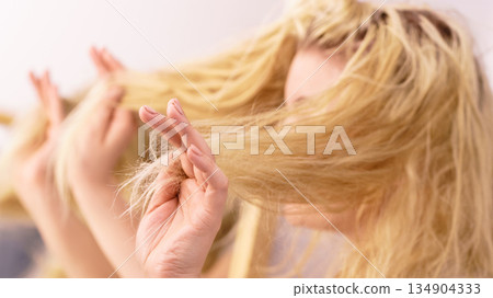 Woman having blonde split ends hair 134904333