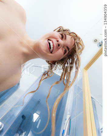 Woman having wet blonde hair 134904359