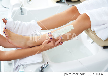 Aplying nourishing moisturizer mask woman legs 134904376