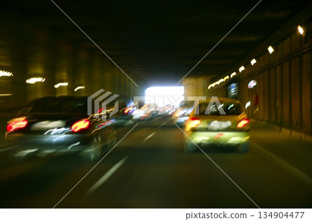 Cars moving traffic with brurred blur headlights on the tunnel Cars moving traffic with brurred blur headlights on the tunnel 134904477