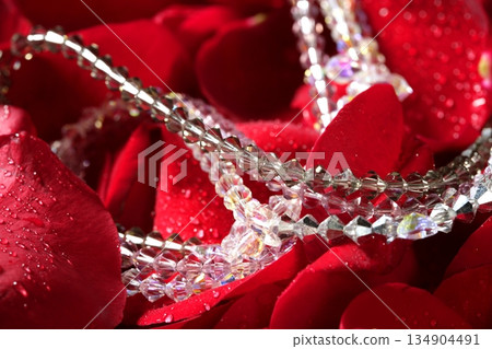 Shiny jewelry over red rose petals 134904491